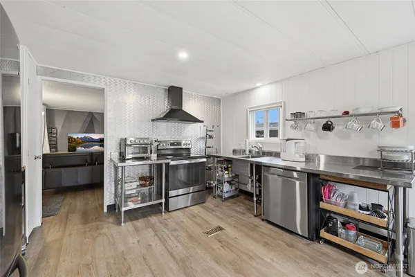 a kitchen with stove a sink and a refrigerator