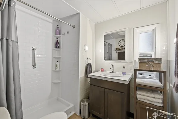 a bathroom with a double vanity sink mirror and shower