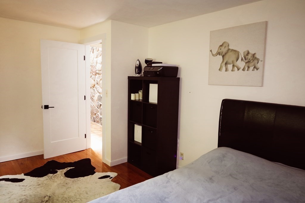 80 Rock-A-Dundee Road Hampden, MA 01036 - Photo 17 of 42 a bedroom with a bed and a painting on the wall