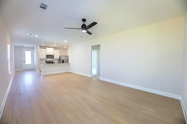 a view of a kitchen with a sink and wooden floor