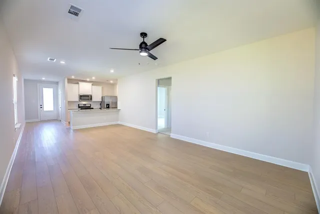 a view of a kitchen with a sink and wooden floor