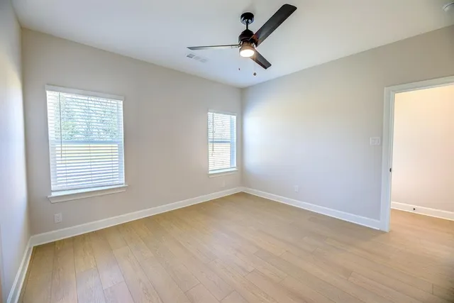 wooden floor in an empty room with a window