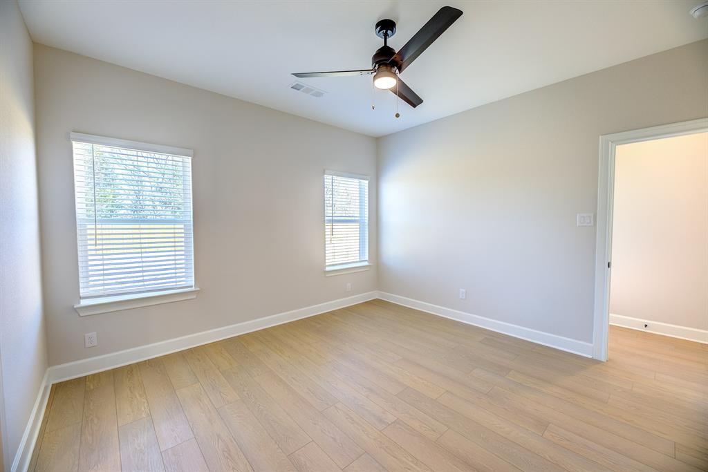 1330 Windemere Way Princeton, TX 75407 - Photo 14 of 25 wooden floor in an empty room with a window
