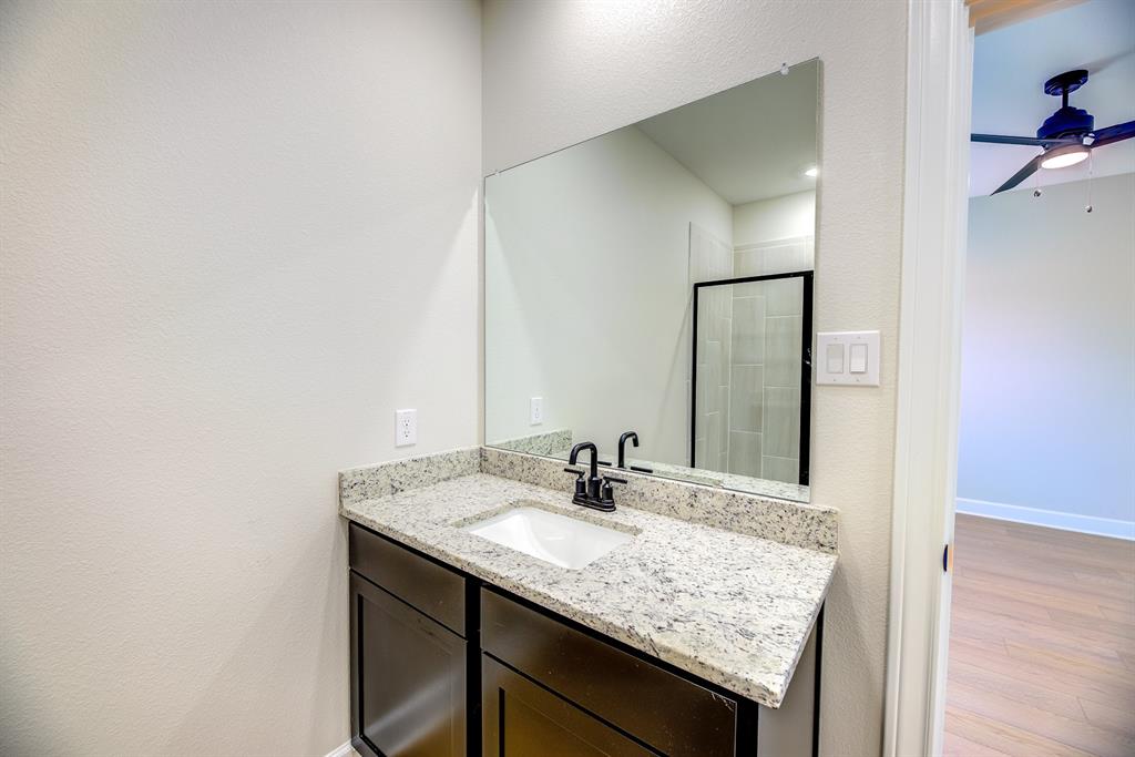 1330 Windemere Way Princeton, TX 75407 - Photo 17 of 25 a bathroom with a granite countertop sink and a mirror