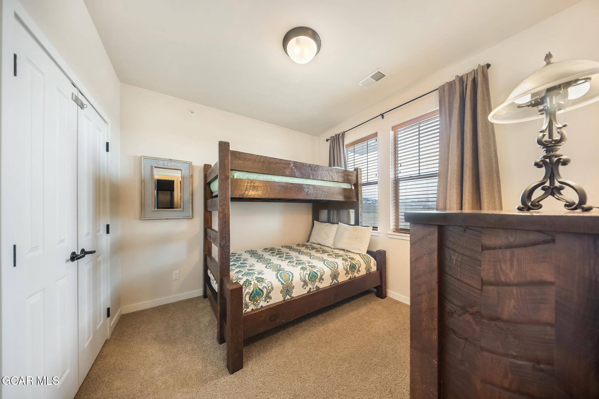162 Village Road, Unit G303 Granby, CO 80446 - Photo 24 of 37 a bedroom with a bed and a window