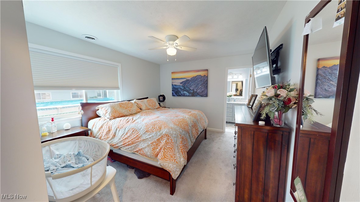 3044 Gale Road Willoughby, OH 44094 - Photo 17 of 30 Carpeted bedroom with ensuite bathroom and ceiling fan