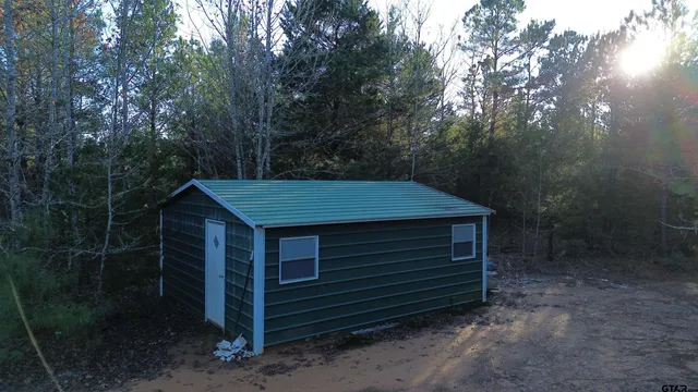 a yellow house with trees in front of it