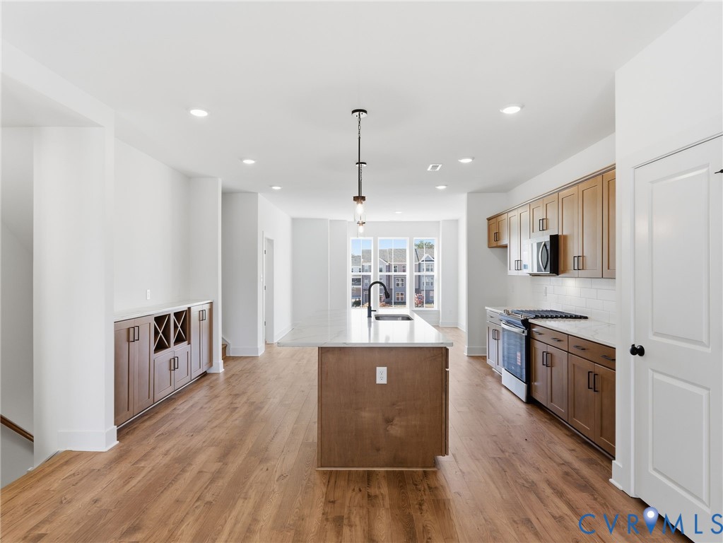 12026 Flowering Lavender Loop Henrico, VA 23233 - Photo 17 of 42 a large kitchen with stainless steel appliances granite countertop a stove and a wooden floors
