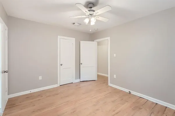 an empty room with fan and a ceiling fan