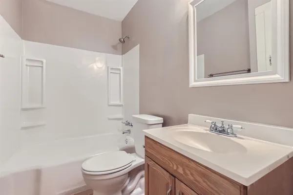 a bathroom with a sink toilet and a mirror