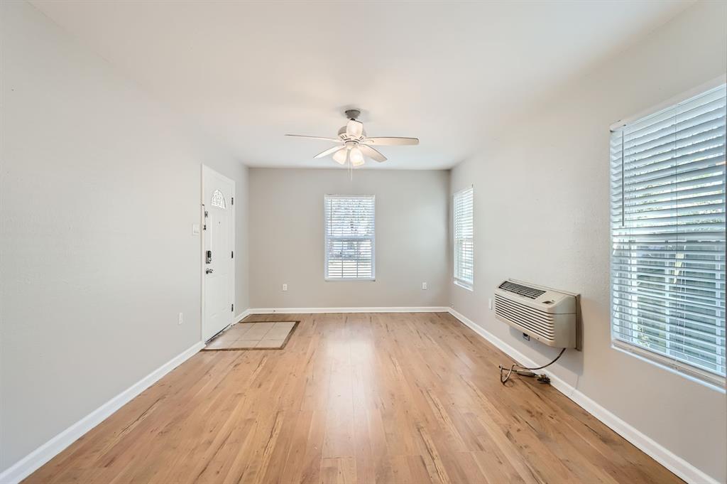 224 East Boyd Street Bonham, TX 75418 - Photo 3 of 28 an empty room with wooden floor and windows