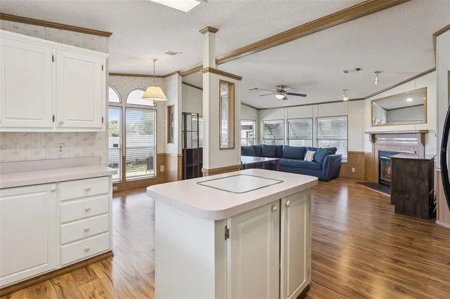 a kitchen with a stove a refrigerator a sink and dishwasher with wooden floor