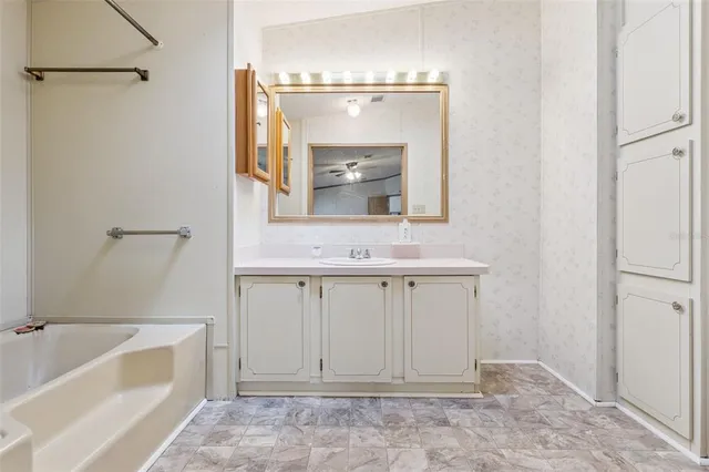 a bathroom with a sink a mirror and a bathtub