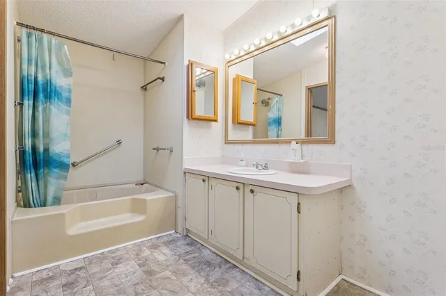 a bathroom with a sink mirror toilet and bathtub