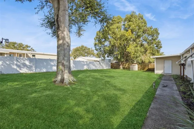a view of a house with backyard and garden