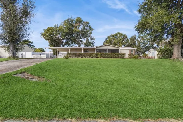 a front view of a house with yard and green space