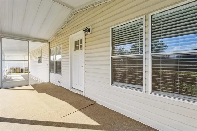 a view of a porch with a table and chairs