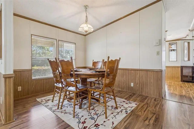 a view of a dining room with furniture and wooden floor
