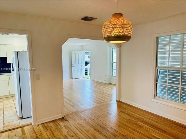 a view of hallway with wooden floor