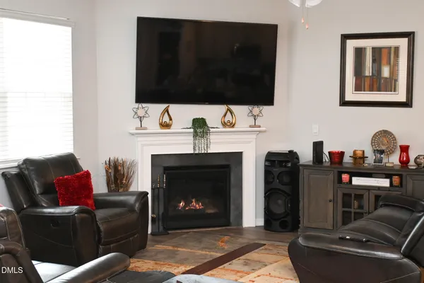 a living room with furniture a fireplace and a flat screen tv