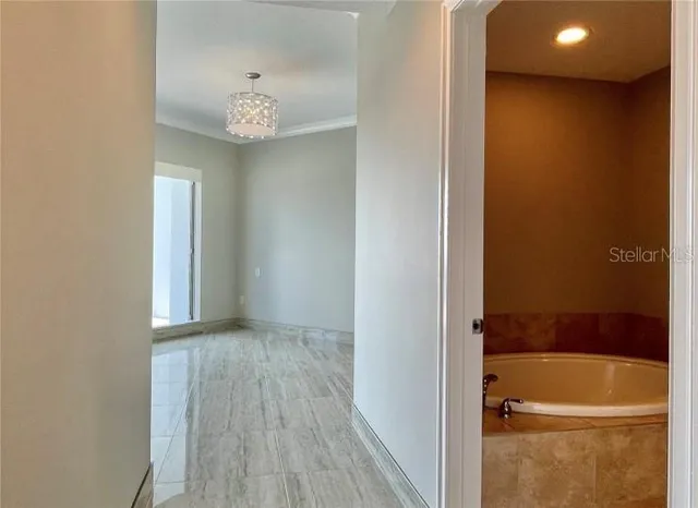 a view of a room with wooden floor and window