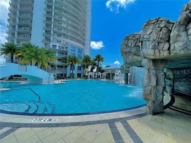 a view of a swimming pool with outdoor seating