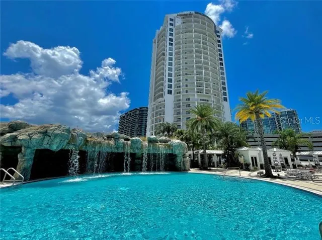 a view of a patio with a table and chairs under an umbrella