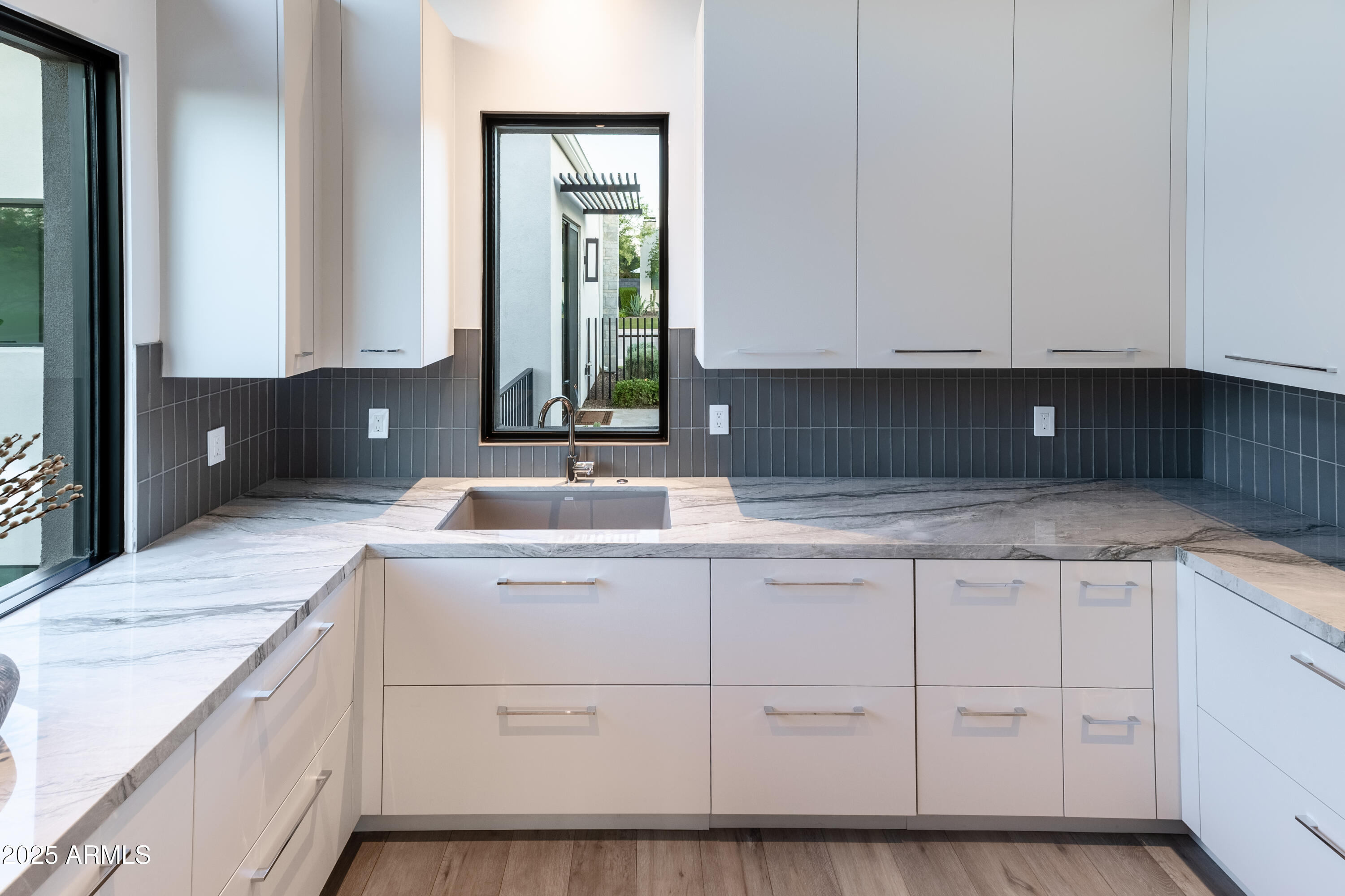 6850 East Joshua Tree Lane Paradise Valley, AZ 85253 - Photo 17 of 39 a kitchen with a sink and cabinets