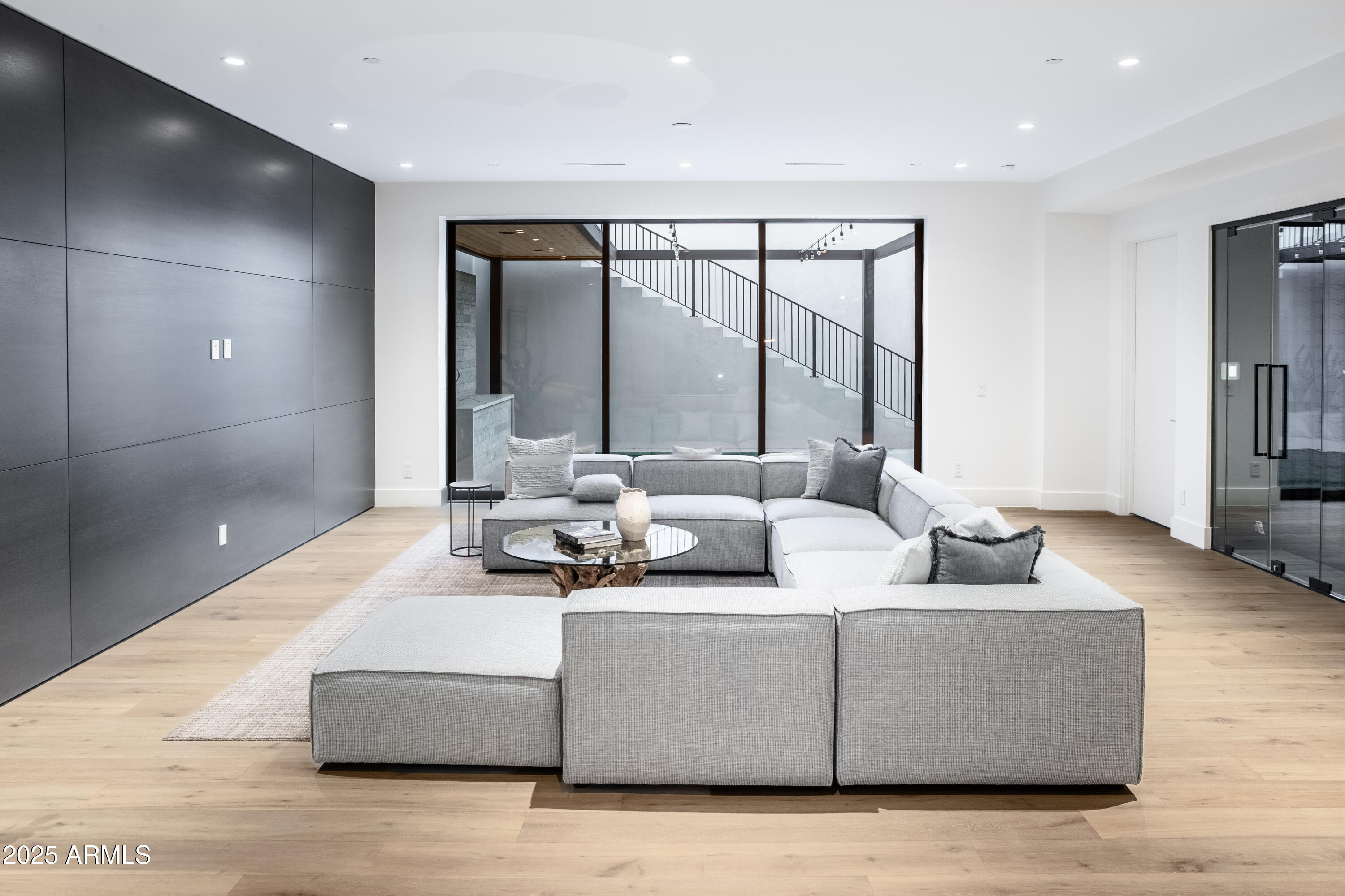 6850 East Joshua Tree Lane Paradise Valley, AZ 85253 - Photo 26 of 39 a living room with couches and a large mirror with wooden floor