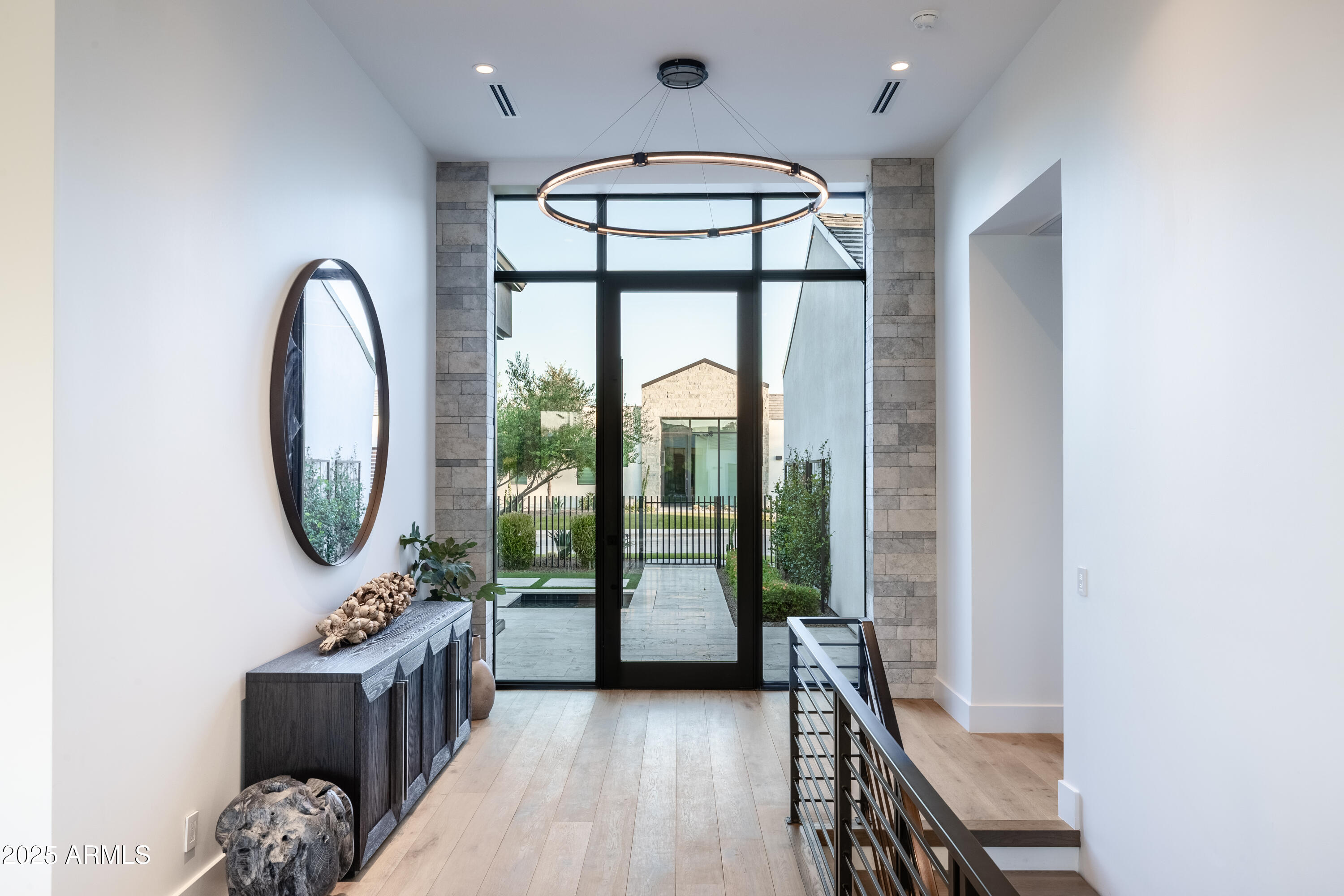6850 East Joshua Tree Lane Paradise Valley, AZ 85253 - Photo 8 of 39 a view of a hallway with windows