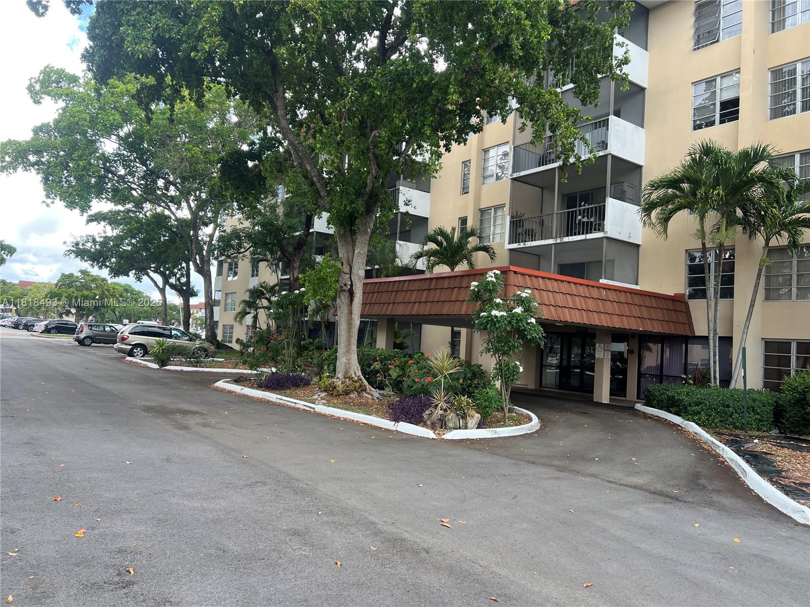 4160 Inverrary Drive, Unit 306 Lauderhill, FL 33319 - Photo 18 of 20 a front view of a house with a garden