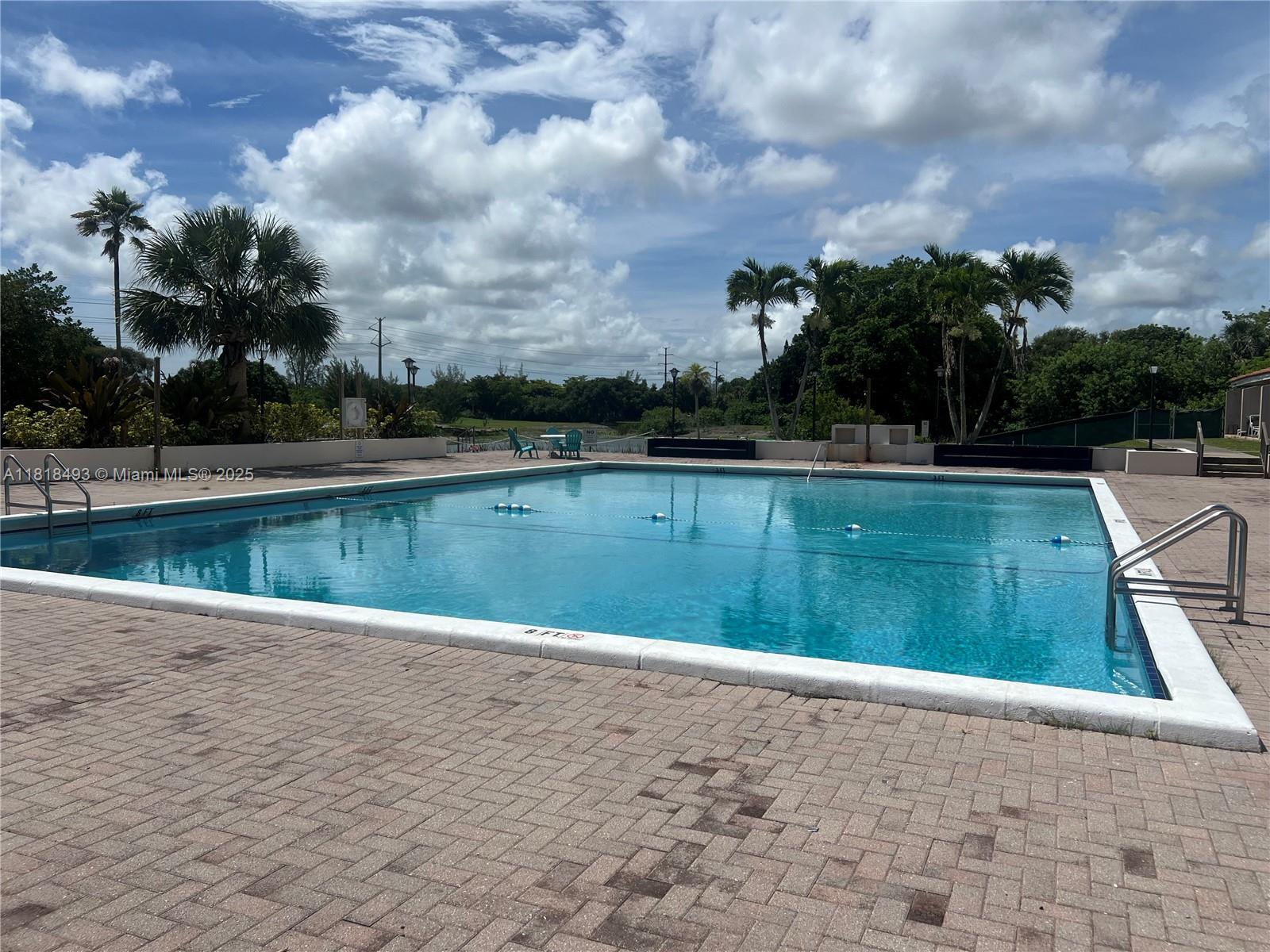 4160 Inverrary Drive, Unit 306 Lauderhill, FL 33319 - Photo 4 of 20 a view of a swimming pool and a yard