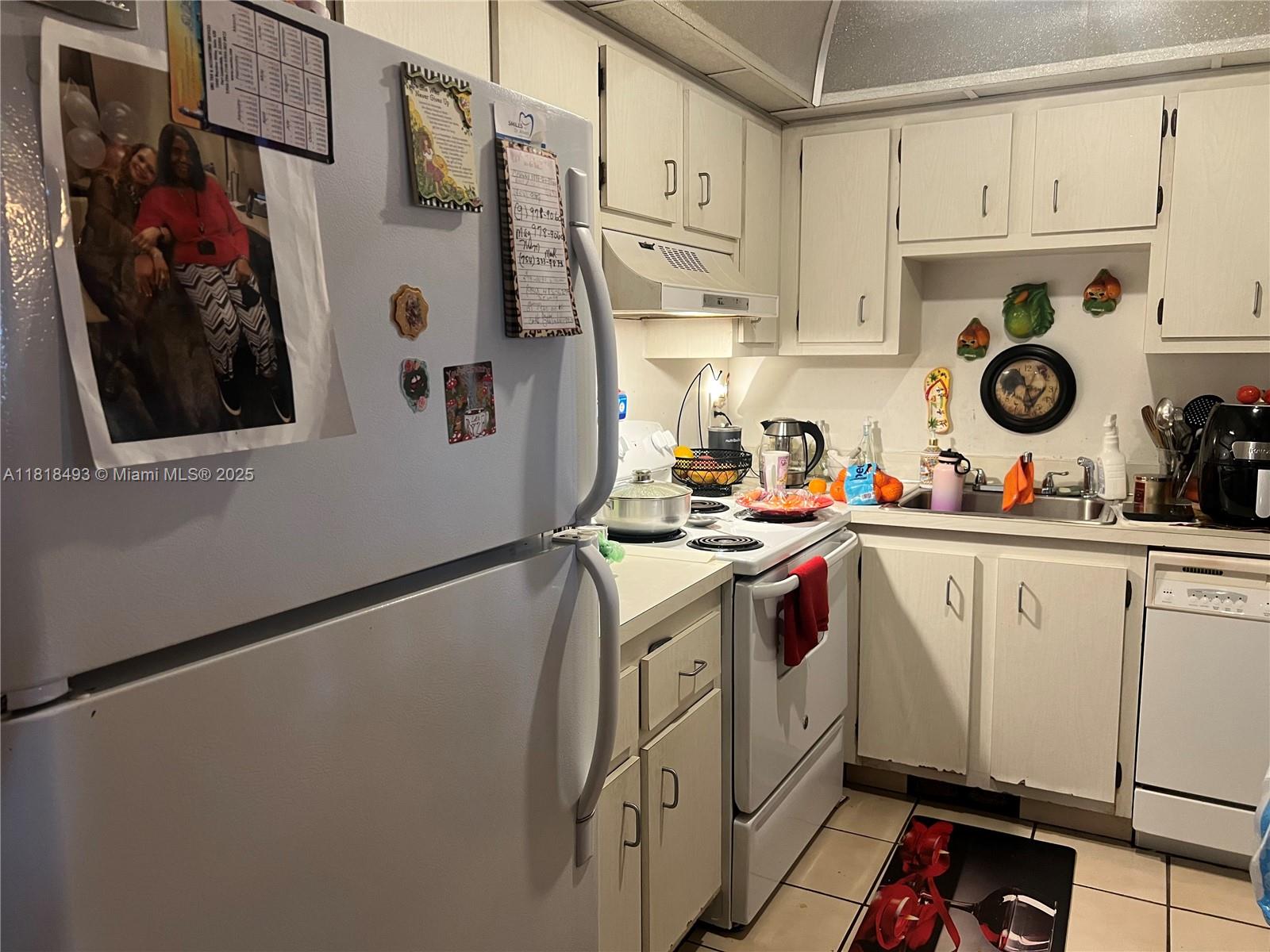4160 Inverrary Drive, Unit 306 Lauderhill, FL 33319 - Photo 10 of 20 a kitchen with stainless steel appliances white cabinets and white appliances