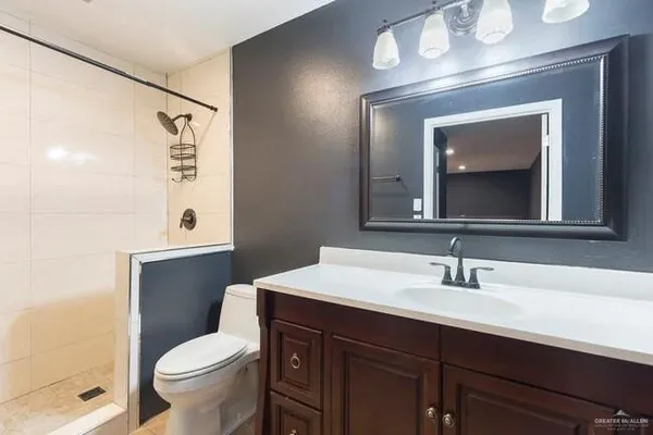 a kitchen with stainless steel appliances kitchen island granite countertop a stove a sink and a refrigerator