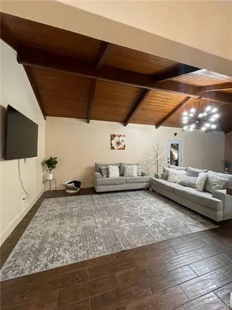 a kitchen with stainless steel appliances kitchen island granite countertop a refrigerator and a sink