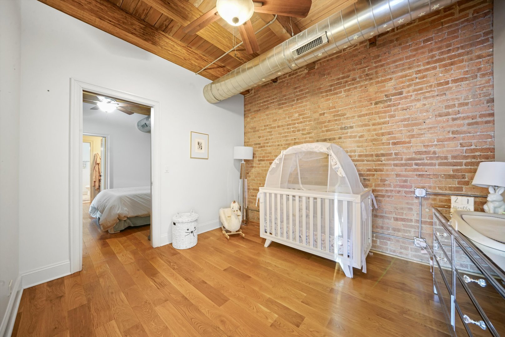 935 West Randolph Street, Unit PH Chicago, IL 60607 - Photo 18 of 35 a bedroom with a bed and wooden floor