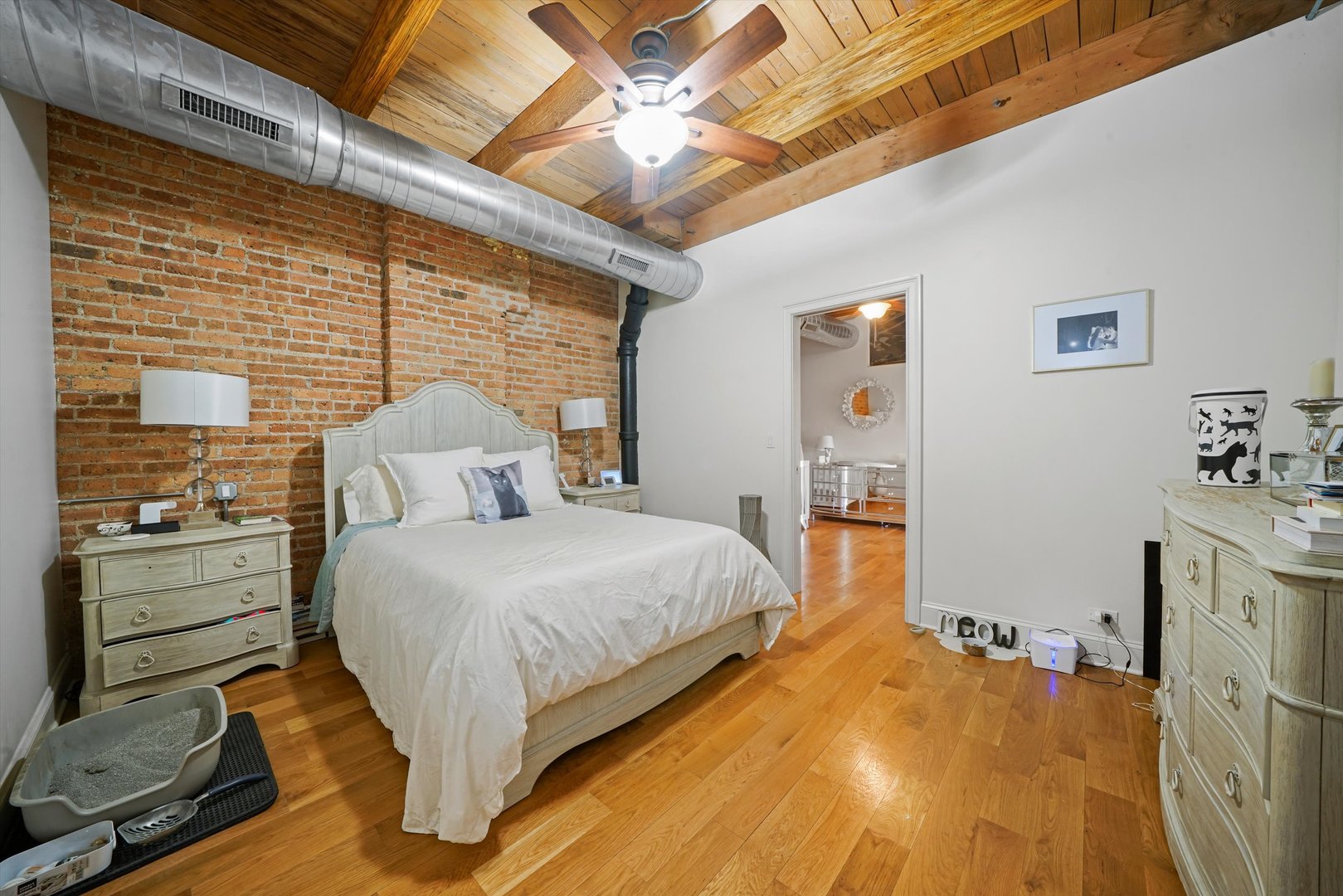 935 West Randolph Street, Unit PH Chicago, IL 60607 - Photo 19 of 35 a bedroom with a bed and a flat tv screen on dresser