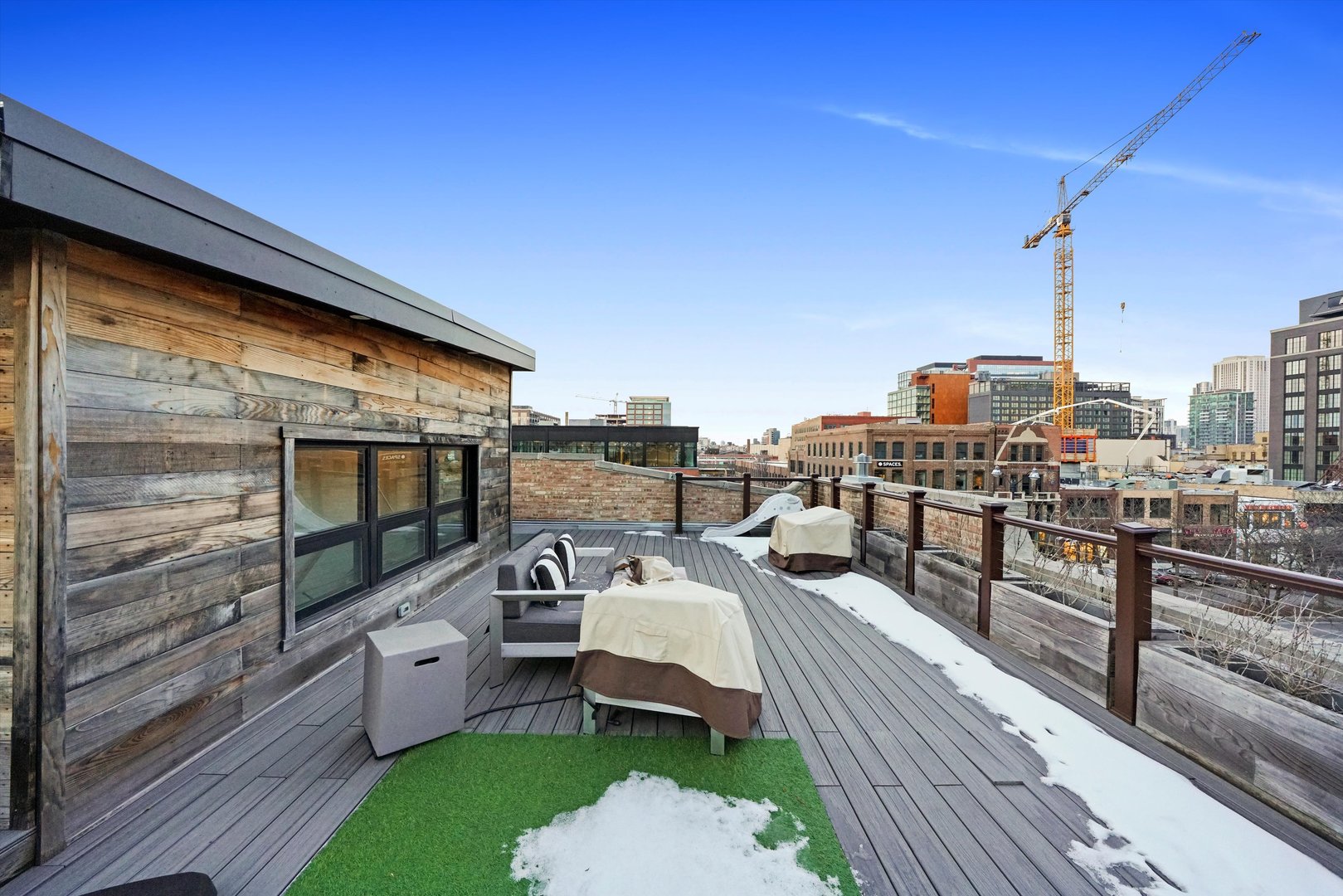 935 West Randolph Street, Unit PH Chicago, IL 60607 - Photo 33 of 35 a balcony with furniture and a flat screen tv