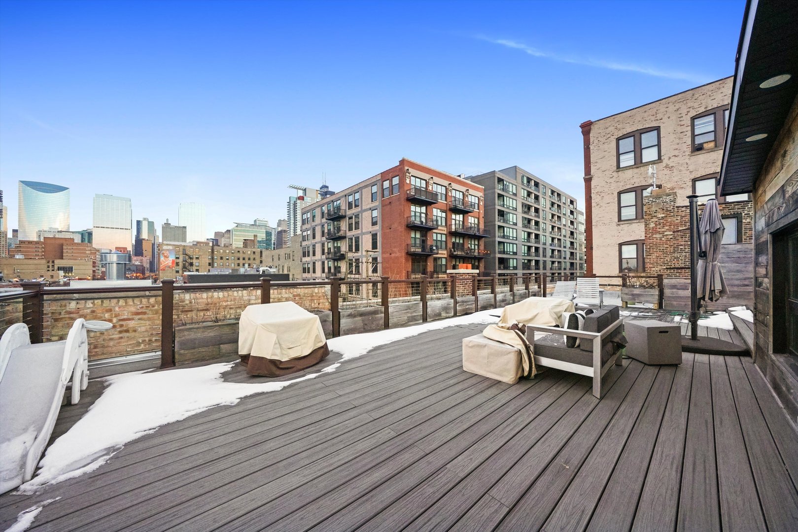 935 West Randolph Street, Unit PH Chicago, IL 60607 - Photo 34 of 35 a balcony with wooden floor table and chairs