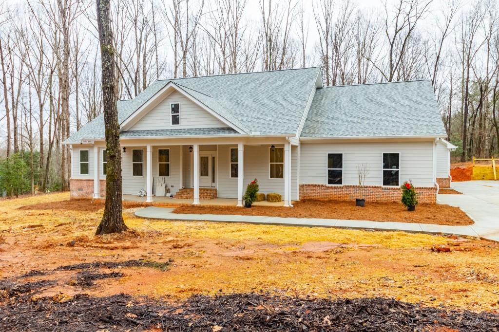 a view of a house with swimming pool and sitting area