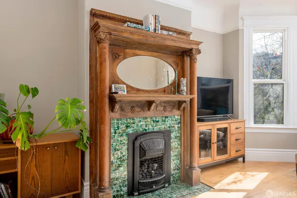 a living room with a fireplace a potted plant and a fireplace