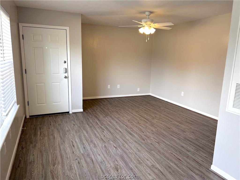 621 West Ridge Drive College Station, TX 77845 - Photo 5 of 13 an empty room with wooden floor chandelier fan and windows