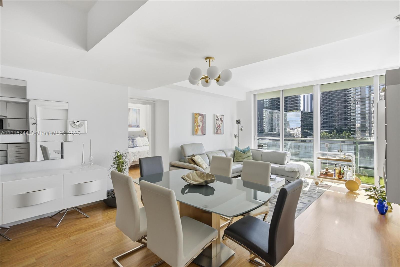 92 Southwest 3rd Street, Unit 1604 Miami, FL 33130 - Photo 11 of 53 a view of a dining room with furniture window and wooden floor