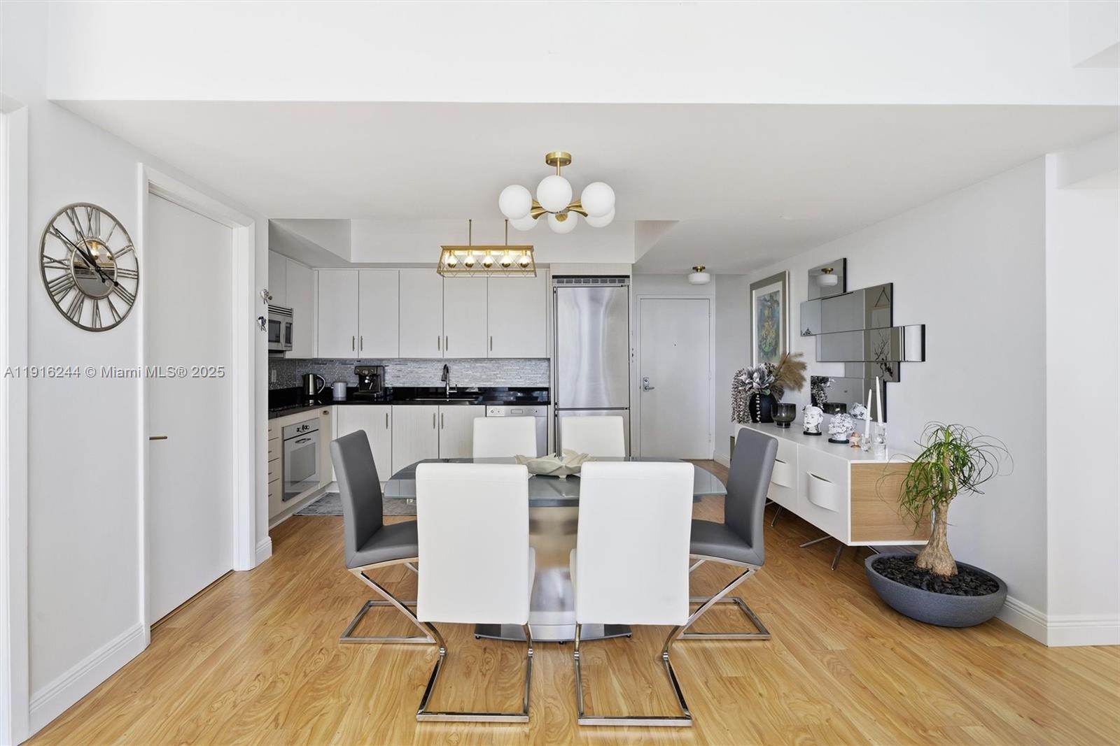 92 Southwest 3rd Street, Unit 1604 Miami, FL 33130 - Photo 14 of 53 a view of a dining room with furniture and wooden floor