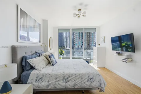 a bedroom with a bed and a flat screen tv