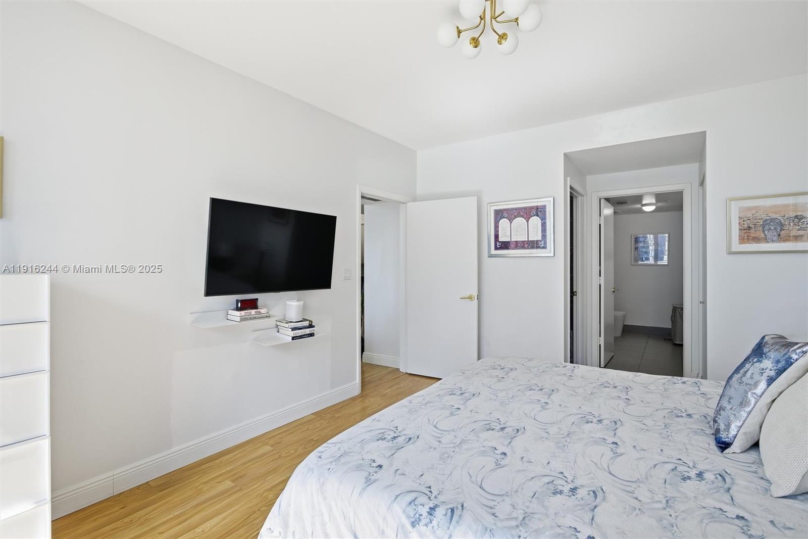 92 Southwest 3rd Street, Unit 1604 Miami, FL 33130 - Photo 19 of 53 a bedroom with a bed and a flat screen tv