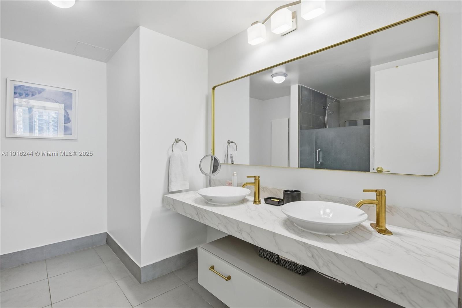 92 Southwest 3rd Street, Unit 1604 Miami, FL 33130 - Photo 20 of 53 a bathroom with a sink and a mirror