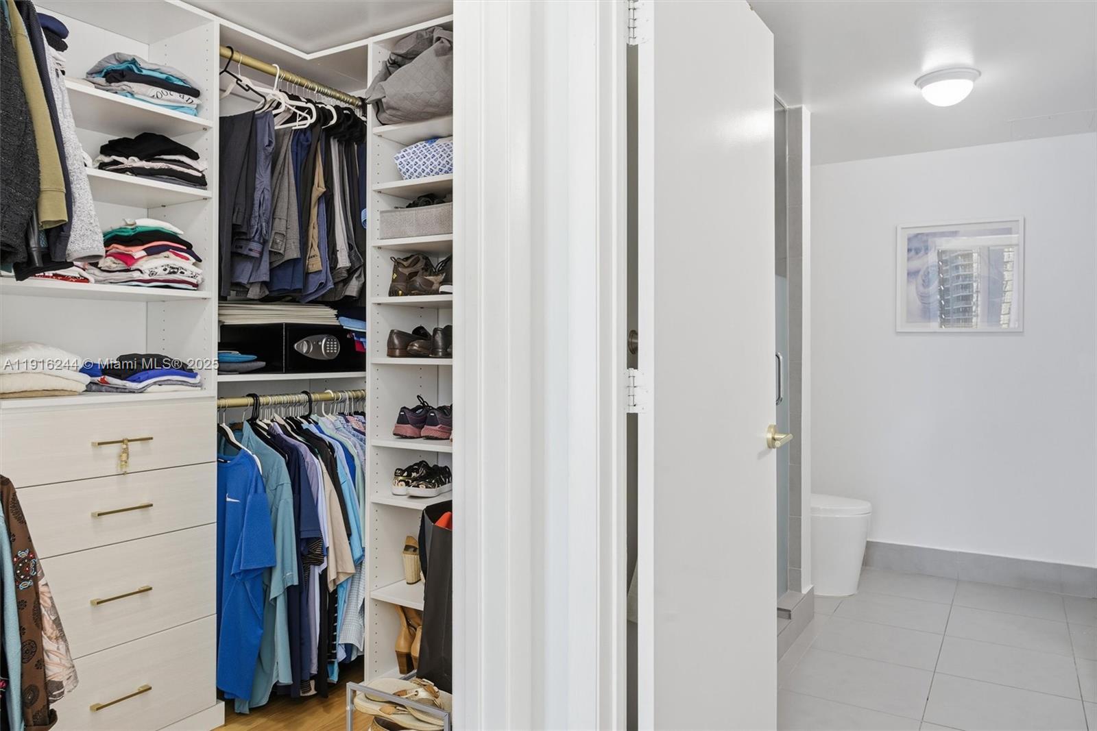 92 Southwest 3rd Street, Unit 1604 Miami, FL 33130 - Photo 21 of 53 a view of walk in closet with clothes and shoes