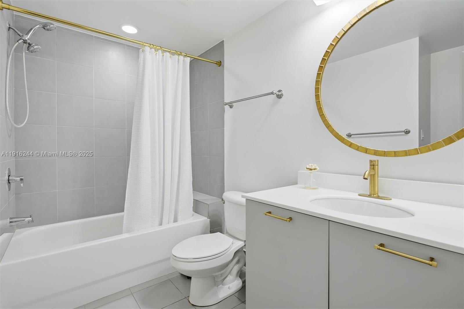 92 Southwest 3rd Street, Unit 1604 Miami, FL 33130 - Photo 26 of 53 a bathroom with a sink a toilet and a mirror