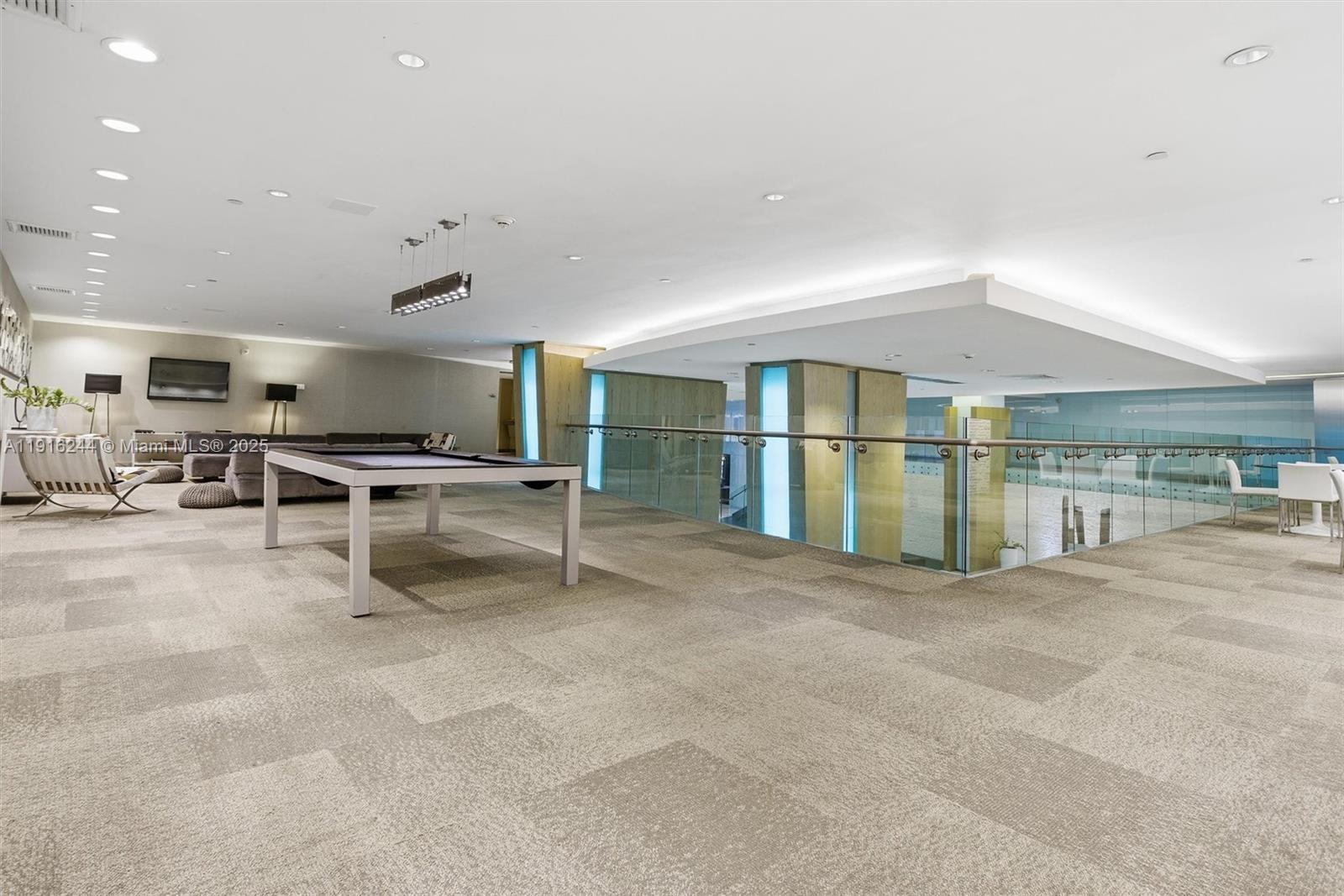 92 Southwest 3rd Street, Unit 1604 Miami, FL 33130 - Photo 42 of 53 a view of a livingroom with furniture and a book shelf